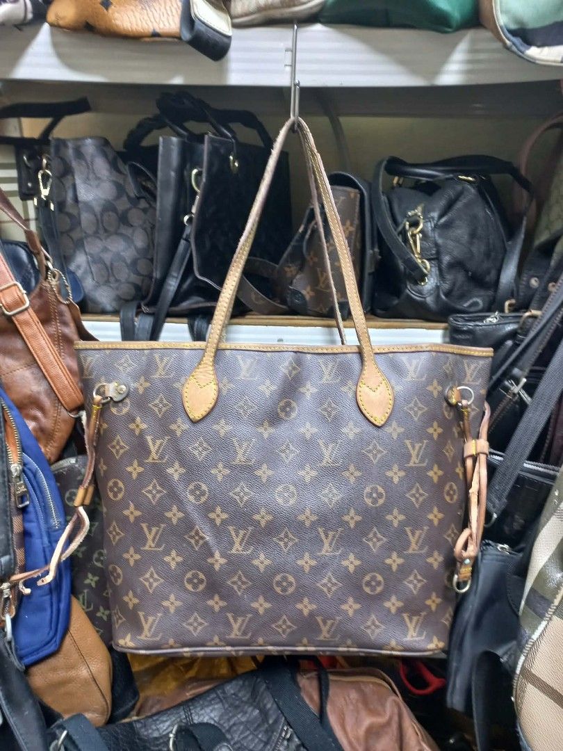 Louis Vuitton Monogram Canvas Tote Bag (Category: Luxury Bags & Wallets) located in Manila. Submitted by dei03_diz (Listing ID 1469880671, Image 2). Description: - Classic monogram canvas tote with brown leather handles and trim - Open top design featuring adjustable side cinch laces - Spacious interior lined with durable striped fabric and gold-tone hardware - Clean canvas body with normal leather darkening and wear around the edges from regular