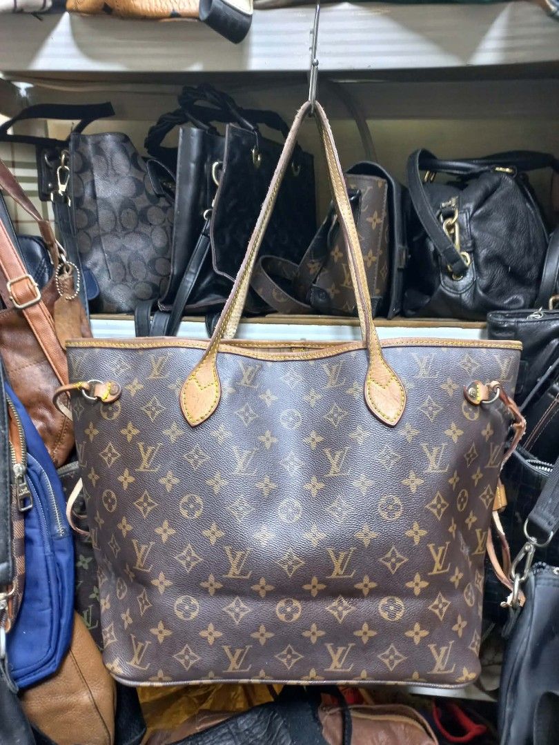 Louis Vuitton Monogram Canvas Tote Bag (Category: Luxury Bags & Wallets) located in Manila. Submitted by dei03_diz (Listing ID 1469880671, Image 1). Description: - Classic monogram canvas tote with brown leather handles and trim - Open top design featuring adjustable side cinch laces - Spacious interior lined with durable striped fabric and gold-tone hardware - Clean canvas body with normal leather darkening and wear around the edges from regular