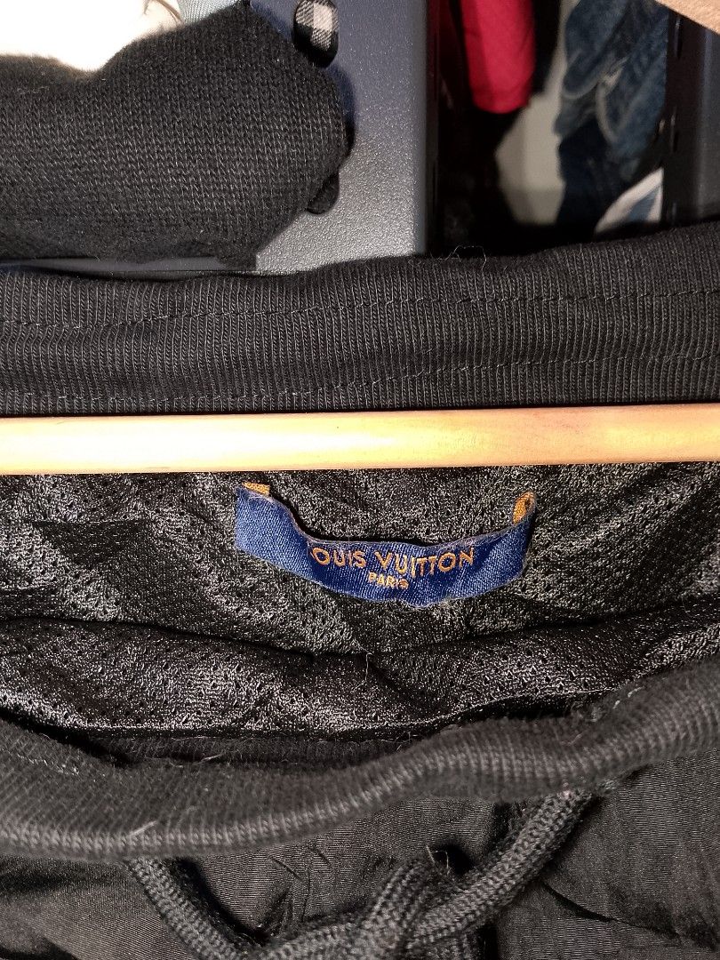 Louis Vuitton Monogram Side Stripe Jogger Pants (Category: Joggers) located in Manila. Submitted by mjthrifted_second (Listing ID 1469806093, Image 3). Description: - Brand: Louis Vuitton - Color: Black with blue & white monogram side stripes - Size: XL - Made in Italy - Material: Nylon and cotton outer with polyester lining - Features: Elastic drawstring waistband and secure back zip pocket - Condition: Comfort meets high-end streetwear style.