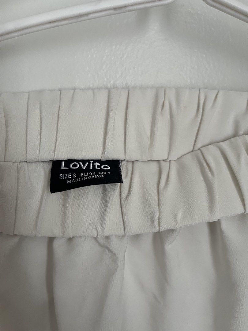 Lovito White Tiered Midi Skirt (Category: Skirts) located in Lapu Lapu. Submitted by alexisdeclutters (Listing ID 1469789052, Image 2). Description: - Brand: Lovito - Color: White - Size: S (EU 34, US 4) - Design: Three-tiered, mid-length skirt - Waistband: Elastic for an easy and comfortable fit - Material: Lightweight fabric with simple pull-on style.