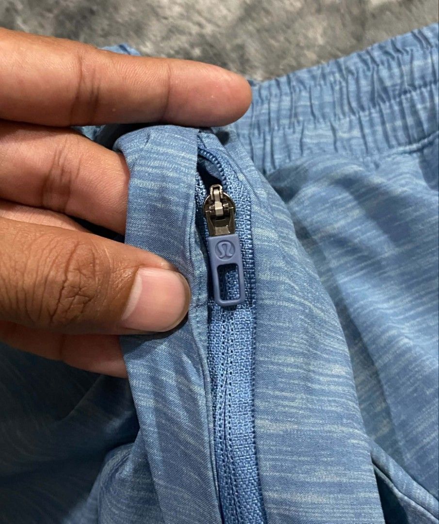 Lululemon Blue Athletic Shorts Size L (Category: Shorts) located in Sorsogon. Submitted by johnmichae69459 (Listing ID 1469812223, Image 2). Description: - Brand: Lululemon - Color: Blue Heathered - Size: Large - 32 to 36 waistline - 19 lenght - Waistband: Elastic with adjustable drawstring - Pockets: Secure zippered side pockets - Details: Iconic Lululemon logo on leg and hardware - Material: Lightweight stretch fabric - Condition: Excellent, re