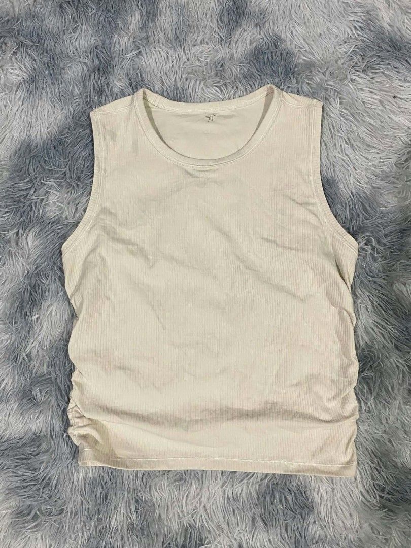 Lululemon Ribbed Tank Top Cream (Category: Sleeveless) located in Manila. Submitted by gemfinds650 (Listing ID 1469901842, Image 1). Description: - Brand: Lululemon - Color: Classic Cream - Style: Round neckline, sleeveless ribbed tank top - Details: Signature silver omega logo at the upper back collar - Fabric: Soft, high-stretch, comfortable material - Condition: Excellent / Great basic piece - Perfect for: Gym workouts, yoga, running errands, 