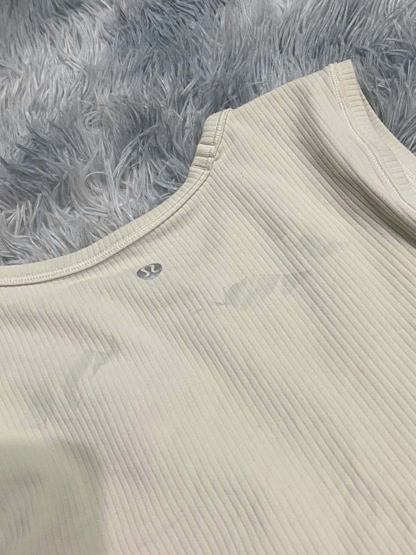 Lululemon Ribbed Tank Top Cream (Category: Sleeveless) located in Manila. Submitted by gemfinds650 (Listing ID 1469901842, Image 2). Description: - Brand: Lululemon - Color: Classic Cream - Style: Round neckline, sleeveless ribbed tank top - Details: Signature silver omega logo at the upper back collar - Fabric: Soft, high-stretch, comfortable material - Condition: Excellent / Great basic piece - Perfect for: Gym workouts, yoga, running errands, 