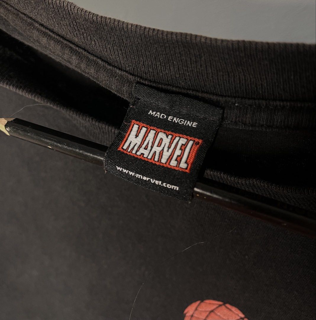 Mad Engine Marvel Spider-Man Black Graphic T-Shirt (Category: Tshirts & Polo Shirts ) located in Cavite. Submitted by ozzyozzx (Listing ID 1469881330, Image 2). Description: - Authentic Mad Engine x Marvel Spider-Man t-shirt - Color: Black - Graphic: Spider-Man crouching pose with red web pattern - Fit: Short sleeves, crew neck collar - Details: Official branding and Marvel website URL on tag - Style: Casual wear for everyday use.