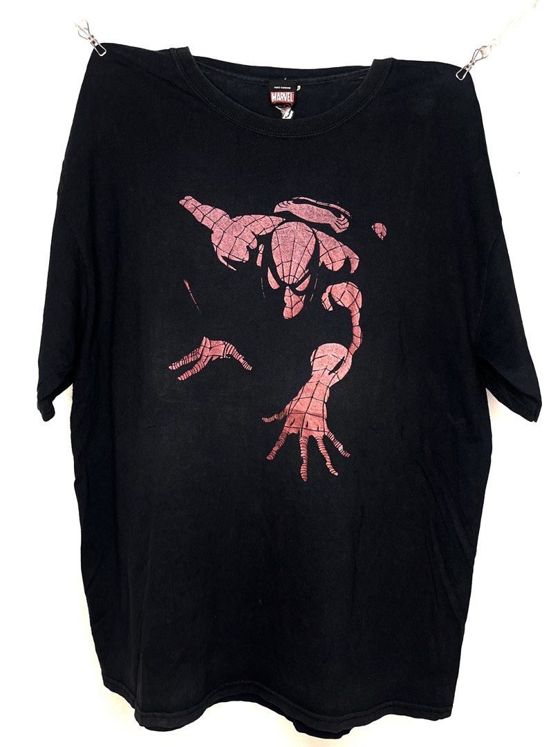 Mad Engine Marvel Spider-Man Graphic T-Shirt Black (Category: Tshirts & Polo Shirts ) located in Cavite. Submitted by ozzyozzx (Listing ID 1469881265, Image 1). Description: - Brand/Collab: Official Mad Engine x Marvel - Design: Classic red web-slinging Spider-Man graphic on the chest - Color/Style: Vintage faded black cotton wash with a worn-in look - Fit: Standard fit, short sleeves, crew neck collar - Condition: Great vintage condition, tagged