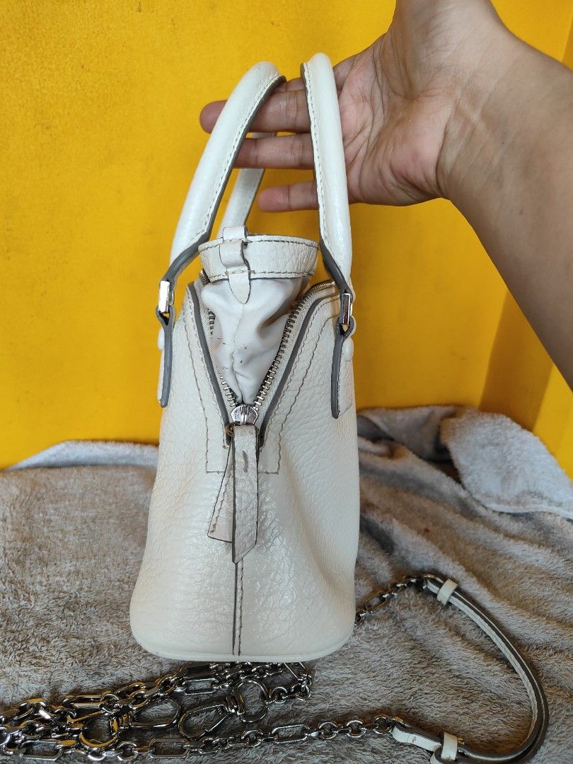 Maison Margiela 5AC Micro White Leather Bag (Category: Luxury Bags & Wallets) located in Cebu City. Submitted by cherreymie70208 (Listing ID 1469786172, Image 3). Description: - Maison Margiela 5AC Micro Bag -Repainted color on leather lips part inside - Color: Textured White Leather - Features iconic numeric logo patch and metal feet on bottom - Dual top handles and detachable chain strap included - Secure zip closure with interior tag (Style co