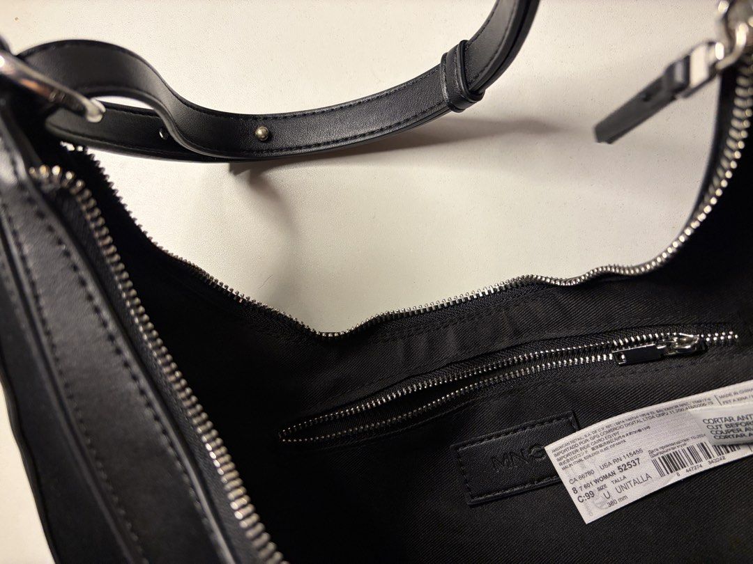 Mango Black Crescent Shoulder Bag (Category: Shoulder Bags) located in Imus. Submitted by jpgworks (Listing ID 1469925408, Image 2). Description: - Brand: Mango - Style: Black crescent shoulder bag - Material: Smooth faux leather - Hardware: Silver tone with zipper closure - Strap: Adjustable with metal buckle - Interior: Lined with an inner zip pocket and brand label tag .