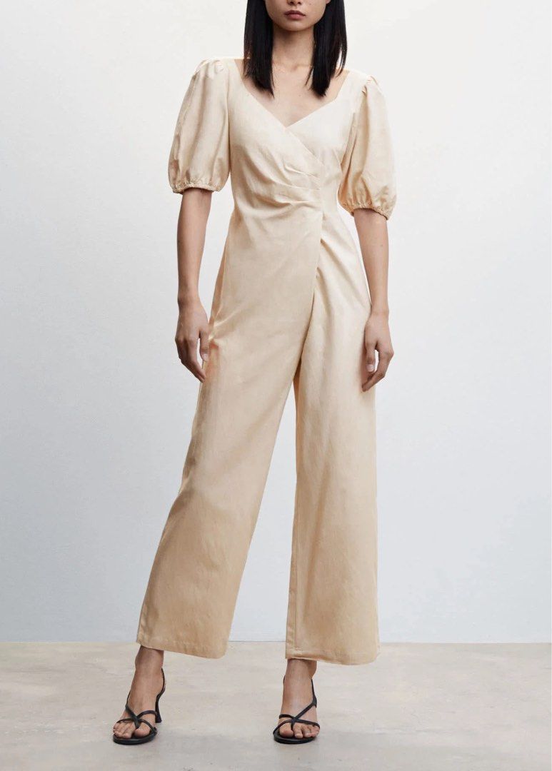 Mango Jumpsuit with Puff Sleeves (Category: Jumpsuits) located in Calamba. Submitted by cheriiv (Listing ID 1469785362, Image 1). Description: Worn once - Color: Neutral beige - Style: Short puff sleeves, crossover wrap front, V-neckline, and wide legs - Closure: Convenient back zip - Material: Light, comfortable fabric - Versatility: Perfect for both casual days and dressy occasions.