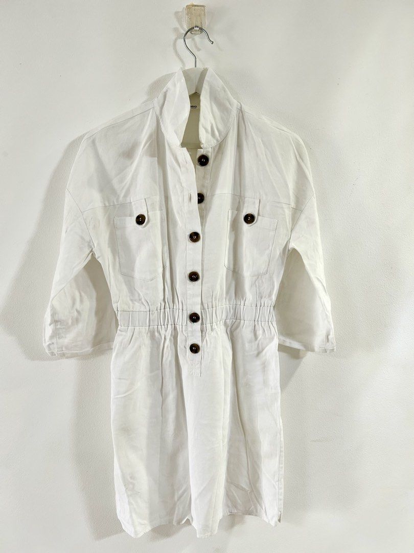 Mango white mini dress (Category: Dresses) located in Manila. Submitted by isabelle_1104 (Listing ID 1469921175, Image 1). Description: - Brand: MNG Casual - Size: EUR S / USA 4 - Color: White - Design: Stand collar with tortoiseshell front buttons - Features: Two chest pockets, comfortable elasticated waistband, and 3/4 sleeves - Origin: Made in Vietnam.