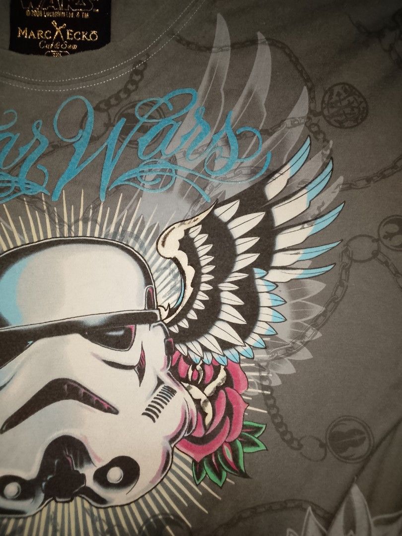 Marc Ecko Star Wars Stormtrooper T-Shirt 2XL (Category: Tshirts & Polo Shirts ) located in Gapan. Submitted by alfiesimon43550 (Listing ID 1469874652, Image 2). Description: - StarWars - Brand: Marc Ecko Cut & Sew (Official 2008 Lucasfilm merch) - Design: Large Stormtrooper graphic with wings, roses, and all-over chain print - Color: Gray with light blue neckline trim - Size: 2XL - Material: 100% Cotton (Made in Mexico) - Condition: Excellent pre