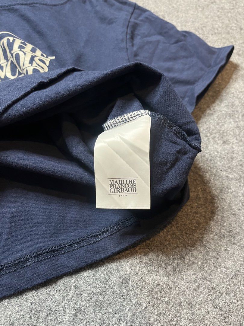 Marithe Francois Girbaud Navy Crop T-Shirt Size S (Category: Shirts) located in Lapu Lapu. Submitted by softfind (Listing ID 1469822717, Image 3). Description: - Brand: Marithe Francois Girbaud - Color: Navy Blue - Size: Small (S) with original woven neck label and inner tag - Design: White box graphic print with Paris branding on the front - Cut: Cropped fit, short sleeves, and crew neckline.