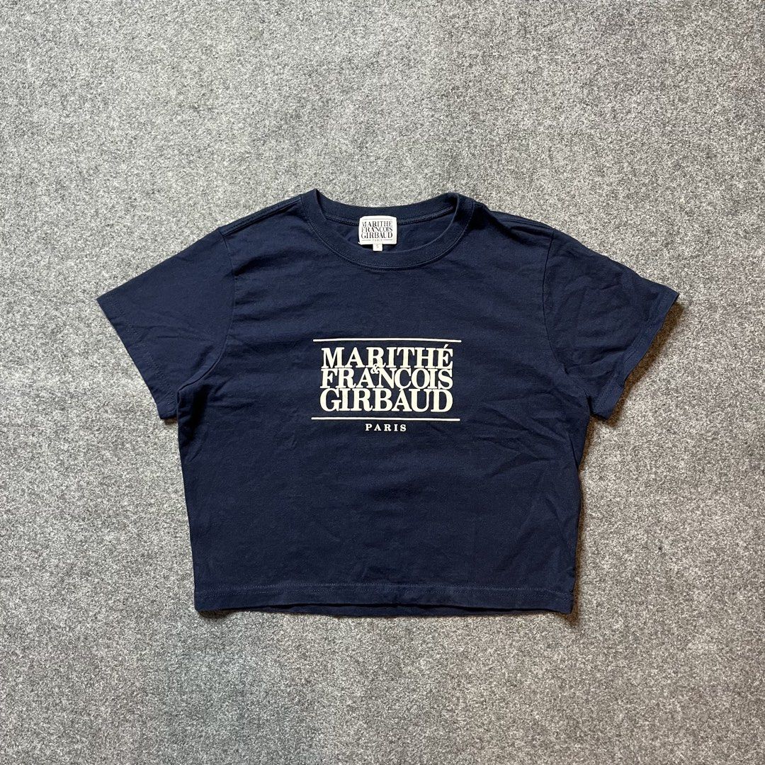 Marithe Francois Girbaud Navy Crop T-Shirt Size S (Category: Shirts) located in Lapu Lapu. Submitted by softfind (Listing ID 1469822717, Image 1). Description: - Brand: Marithe Francois Girbaud - Color: Navy Blue - Size: Small (S) with original woven neck label and inner tag - Design: White box graphic print with Paris branding on the front - Cut: Cropped fit, short sleeves, and crew neckline.
