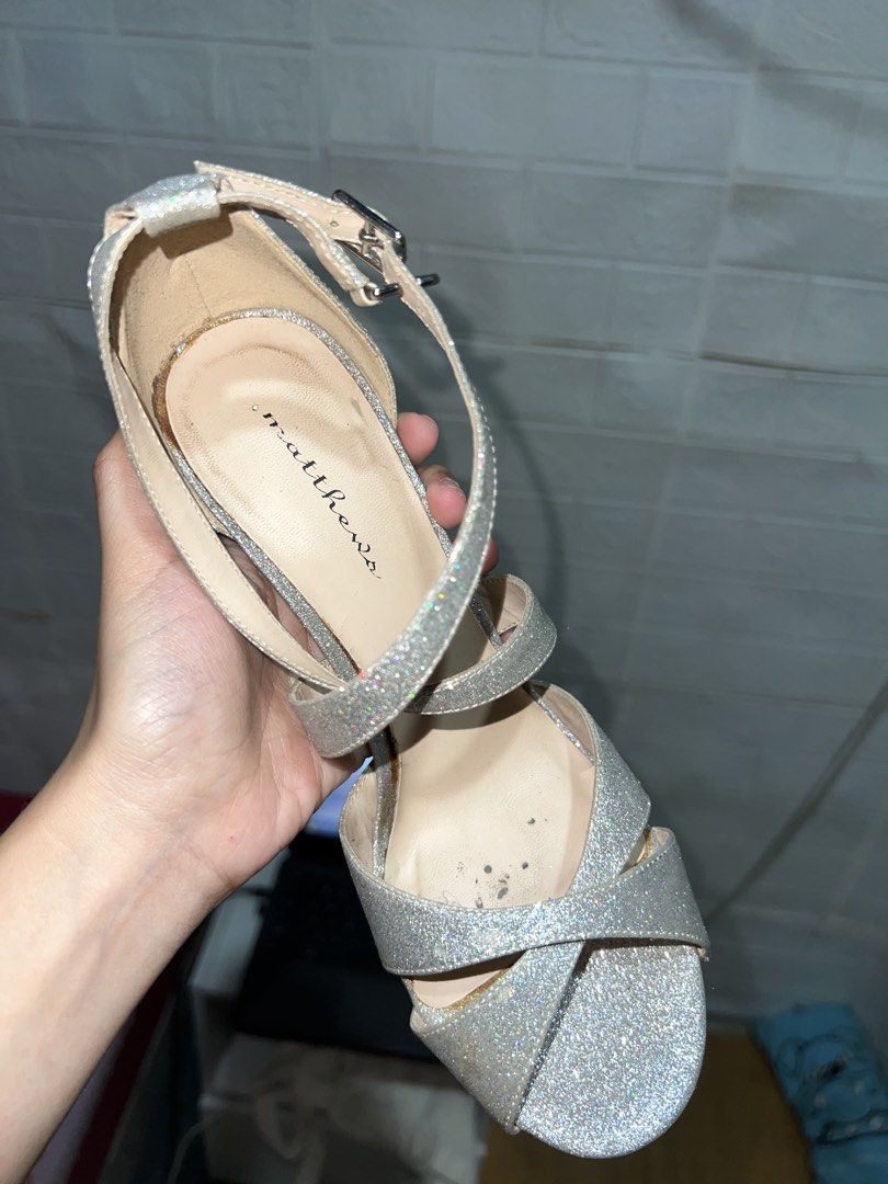 Matthews Silver Glitter Stilettos Heels (Category: Heels) located in Santa Rosa. Submitted by truecat.9d0628 (Listing ID 1469895262, Image 3). Description: - Brand: Matthews - Color/Finish: Silver glitter - Style: Strappy high heels with open toe and ankle buckle closure - Inclusions: Original black box and dust cover - Condition: Signs of wear visible on the inner sole and edges.