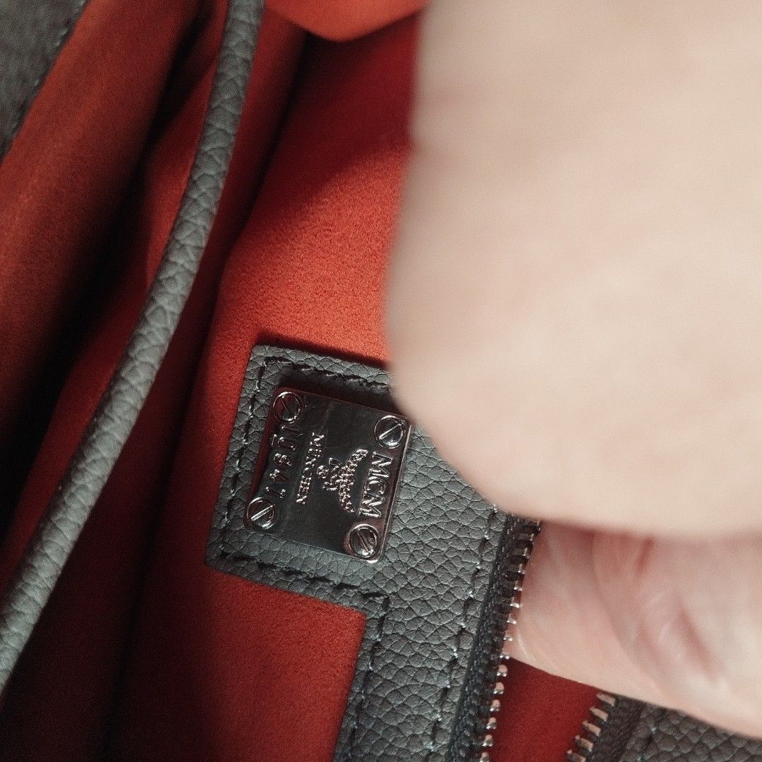 MCM Grey Studded Crossbody Bag (Category: Cross-body Bags) located in Manila. Submitted by lene48 (Listing ID 1469855469, Image 3). Description: Grey pebbled leather crossbody bag from MCM. Silver-tone hardware and stud details along the flap and edges. Front push-lock closure featuring the MCM logo. Back slip pocket includes a debossed logo. Bright orange interior lining with a zippered pocket and metal brand plaque. Made in Italy.flaw sa rubber