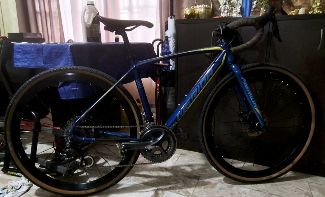 Merida cyclocross 300 Gravel (Category: Bicycles) located in Las Pinas. Submitted by Rmtn14 (Listing ID 1469915022, Image 1). Description: - Model: Merida 300 Road Bike (Blue and Yellow) - Crankset: Upgraded Ultegra crankset - Brakes: Front and rear disc brakes - Wheels & Tires: Deep dish wheels with stylish tan wall tires - Cockpit: Drop handlebars with clean dark tape - Saddle: Black saddle on an adjustable seatpost - Condition: Fully tuned dri