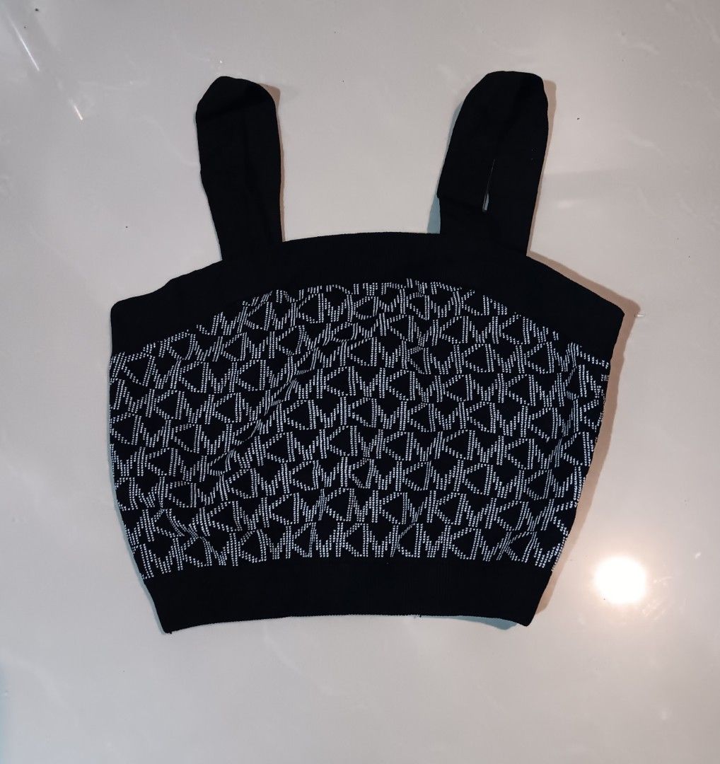 Michael Kors Black Monogram Knit Crop Top (Category: Blouses) located in Manila. Submitted by mysticowl-11c6 (Listing ID 1469911931, Image 1). Description: - Brand: Michael Kors - Style: Sleeveless crop top with square neckline - Design: Classic black and white MK monogram knit pattern - Details: Ribbed trim along the neckline and hem - Size: XS - Material: Soft stretch knit blend including recycled viscose, nylon, polyester, and elastane - Condi