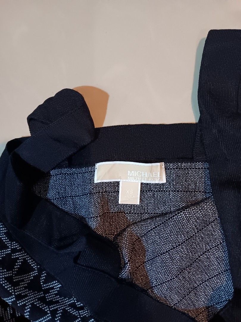 Michael Kors Black Monogram Knit Crop Top (Category: Blouses) located in Manila. Submitted by mysticowl-11c6 (Listing ID 1469911931, Image 3). Description: - Brand: Michael Kors - Style: Sleeveless crop top with square neckline - Design: Classic black and white MK monogram knit pattern - Details: Ribbed trim along the neckline and hem - Size: XS - Material: Soft stretch knit blend including recycled viscose, nylon, polyester, and elastane - Condi