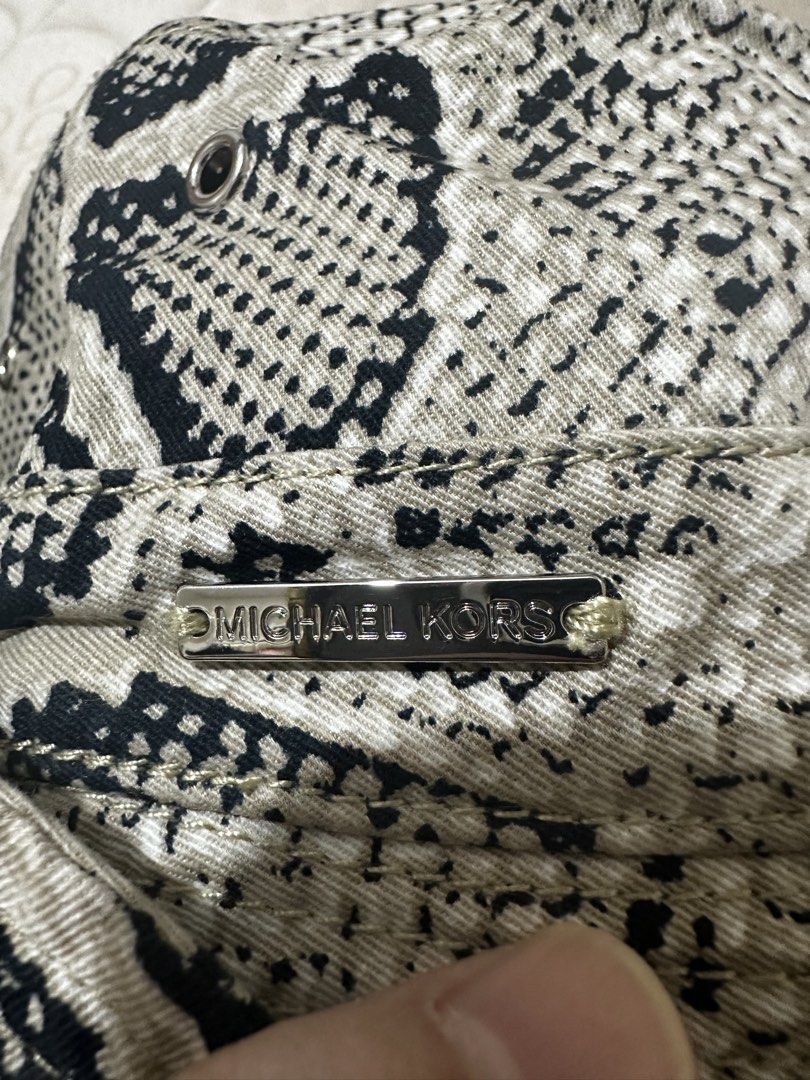 Michael Kors Snake Print Bucket Hat (Category: Hats & Beanies) located in Balanga. Submitted by jamilbeauty5 (Listing ID 1469890090, Image 2). Description: - Brand: Michael Kors - Design: Snake print pattern in black and beige - Details: Signature metal logo plaque on the front - Interior: Black inner lining with size and material tag - Size: One size fits all - Style: Great for sunny days or casual streetwear - Guaranteed authentic! .