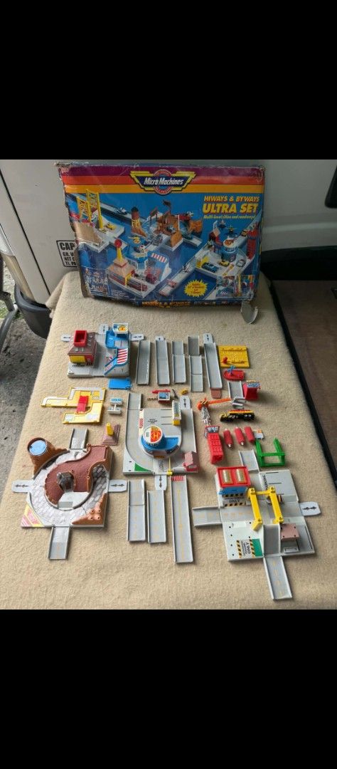 Micro Machines Hiways & Byways Ultra Set (Category: Kids Toys) located in Manila. Submitted by ponga1619 (Listing ID 1469799356, Image 1). Description: - Vintage Galoob Micro Machines Hiways and Byways Ultra Set - Features a multi-level city and road system as - Includes original box with minor corner wear - Comes with modular road pieces, bridges, buildings, mini vehicles, and accessories laid out on cloth - Ideal collectible set for vintage toy