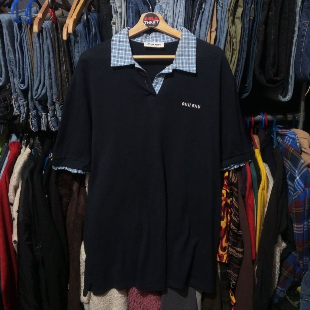 Miu Miu Layered-effect polo Shirt (Category: Activewear) located in Cabuyao City. Submitted by o.gl.athrift (Listing ID 1469902536, Image 1). Description: Miu Miu Layered-effect polo Shirt *Navy blue *short front button fastening *short side slits *embroidered logo 24 Inches width 31 Inches Length Condition: Excellent Issue: minimal distress at the sleeve ( which add as a design) and missing 2 buttons Mine: 1199+sf.