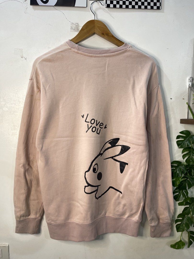 MOREBRAVE Pink Pikachu Graphic Sweatshirt Size M (Category: Coats, Jackets and Outerwear) located in Cabagan. Submitted by blessingma81004 (Listing ID 1469770659, Image 3). Description: - Brand: MOREBRAVE - Design: Pikachu graphic on front and back with "Love you" text on the back - Color: Pink - Size: Tagged M (fits like a Large) - Measurements: Width 19.5 inches, Length 27.5 inches - Material: 100% cotton (Made in China) - Condition: Shows some