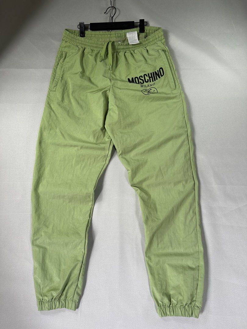 Moschino Lime Double Face Smiley Jogger Pants (Category: Joggers) located in Cabanglasan. Submitted by thefashiongarage.co (Listing ID 1469779846, Image 1). Description: Title - Moschino Couture Model/Name - Double Smiley Face Size on Tag - Medium Conditiion - Excellent as new with no issue Dimension (WxLxH) - 17x42 Inches Category- Casual Fitting - Loose Jogger Made in - Marocco Material - 100% Nylon Color - Lime Green Design - Double Smiley Fac