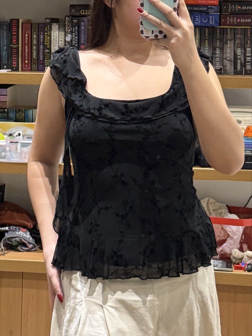 MOTEL ROCKS Black sleeveless ruffled top with subtle floral pattern (Category: Sleeveless) located in Meycauayan. Submitted by m4teri4lgirl (Listing ID 1469773651, Image 1). Description: NEW & UNUSED NO TAGS Color: Black with faint floral pattern - Style: Sleeveless with square neckline and ruffled trim - Fit: True to size, slight flare hem with ruffle detail - Versatility: Easy to style with trousers or shorts.