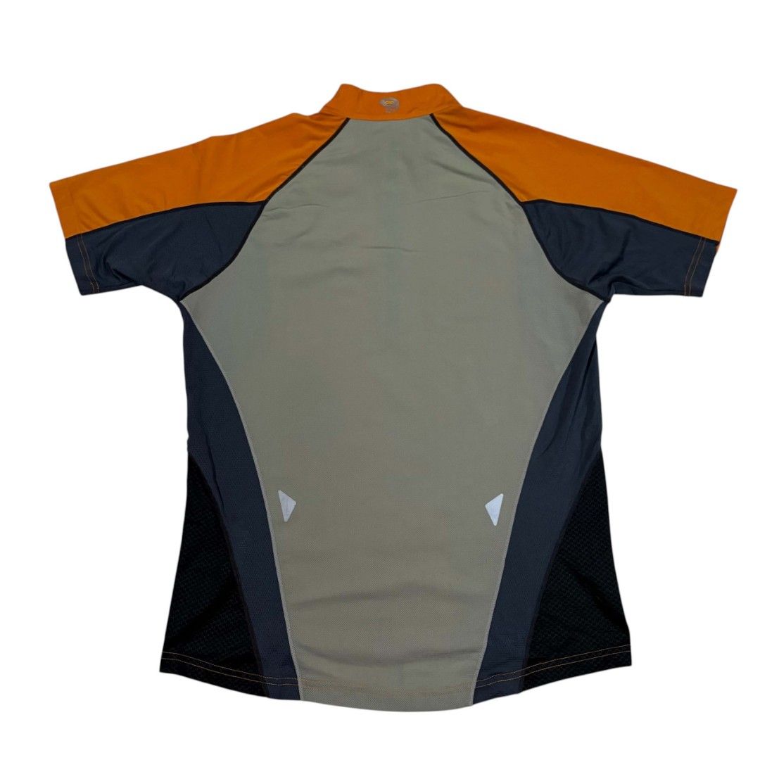 Mountain Hardwear Short Sleeve (Category: Activewear) located in Cagayan de Oro. Submitted by lootfindzzzz (Listing ID 1469915830, Image 2). Description: - Brand: Mountain Hardwear - Style: Athletic cycling jersey with half-zip front and mock neck - Colors: Vibrant orange, dark gray, and light green colorblock design - Breathability: Mesh side panels for enhanced airflow during intense workouts - Safety: High-visibility details and reflective tab