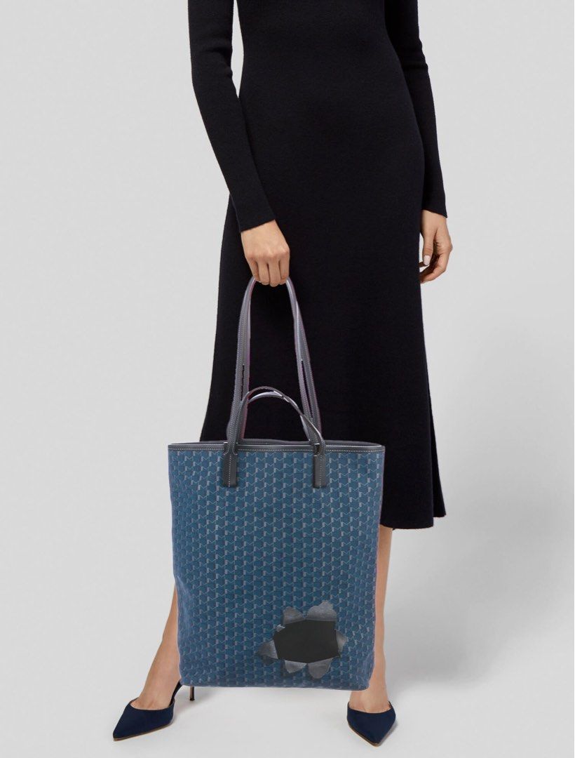 Moynat Paris Monogram Blue Canvas Tote Bag authentic (Category: Tote Bags) located in Manila. Submitted by sanmer25 (Listing ID 1469768179, Image 2). Description: - Brand: Moynat Paris - Material: Blue canvas with dark leather straps and trim - Design: Iconic repeating monogram print with open-top everyday style - Interior: Brown fabric lining with an open slip pocket and leather brand tag - Inclusion: Comes with original brown dust bag and card 