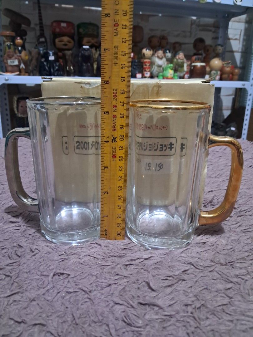Mug (Category: Dinnerware & Cutlery) located in Cavite. Submitted by secretjapansurplus (Listing ID 1469903140, Image 3). Description: Vintage Kirin Beer 2001 Memorial Mug Set (Pair) • Condition: Brand New Old Stock (Mugs are unused and pristine; original campaign box is old and shows visible storage wear). • Features: Collectible pair from the Japan Kirin "Try! Beer Tank 21" campaign. Includes one Gold-accented mug and one Silver-accented mug wi