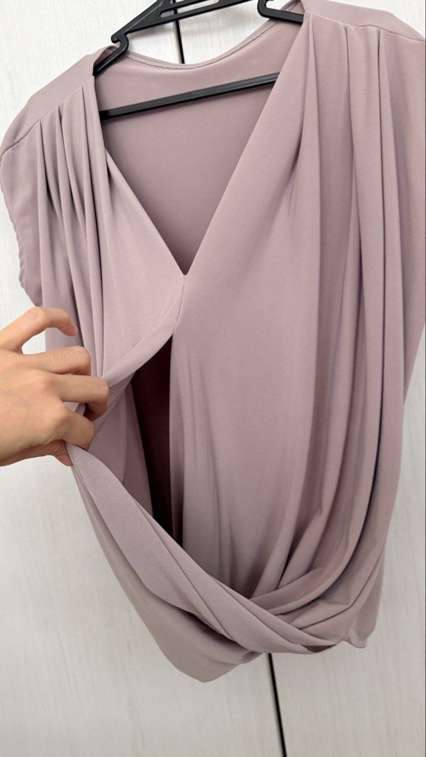 Myka limchoc breast feeding tops (Category: Sleeveless) located in Pasay City. Submitted by crc21 (Listing ID 1469774741, Image 3). Description: - Style: Sleeveless blouse with draped V-neck and front wrap detail - Details: Pleated shoulders, solid color design - Material: Smooth, comfortable fabric that is easy to pair with skirts or pants - Colors Available: Mauve, white, and black - Condition: Clean and ready to wear.