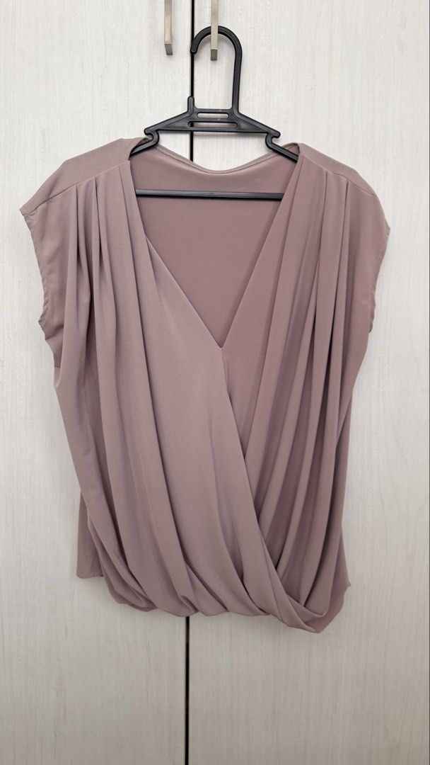 Myka limchoc breast feeding tops (Category: Sleeveless) located in Pasay City. Submitted by crc21 (Listing ID 1469774741, Image 2). Description: - Style: Sleeveless blouse with draped V-neck and front wrap detail - Details: Pleated shoulders, solid color design - Material: Smooth, comfortable fabric that is easy to pair with skirts or pants - Colors Available: Mauve, white, and black - Condition: Clean and ready to wear.