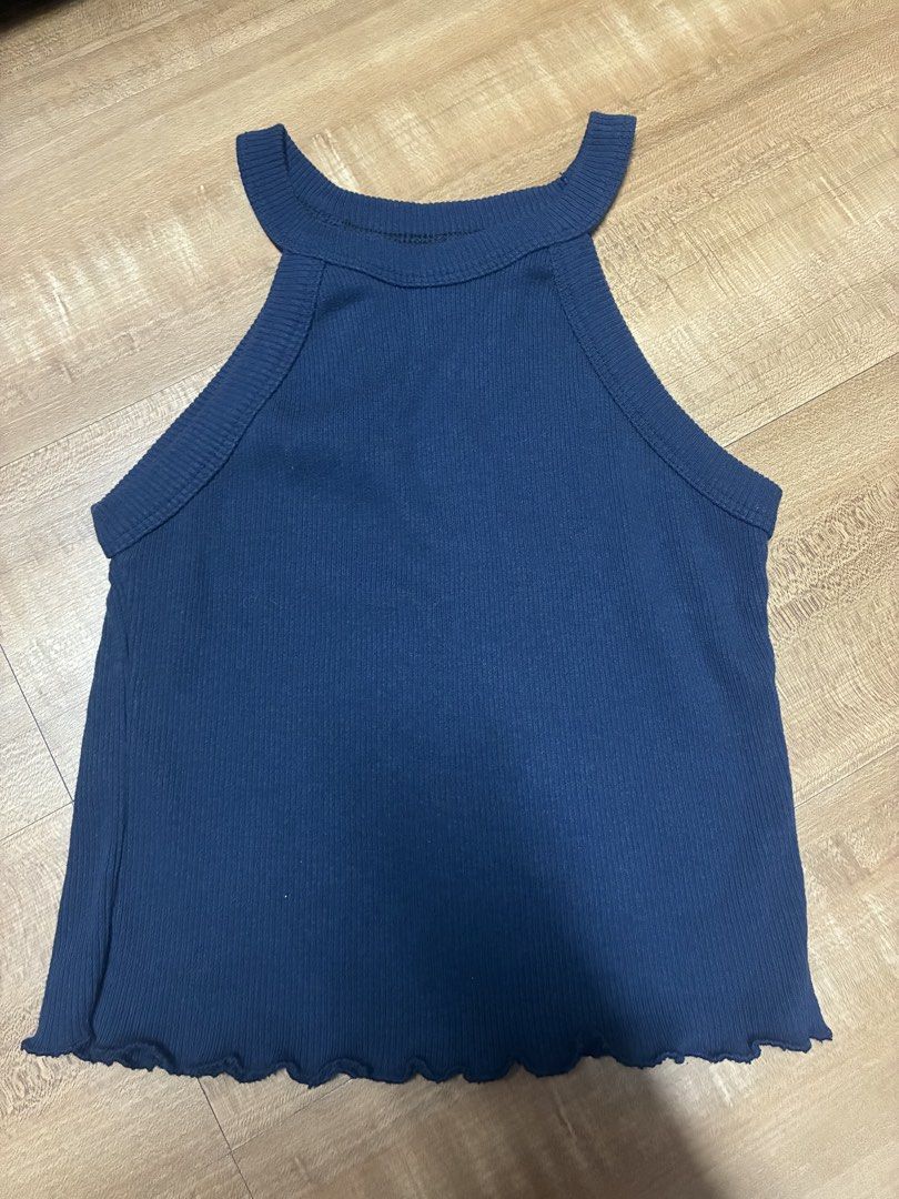 Navy blue ribbed halter neck sleeveless top (Category: Sleeveless) located in Quezon City. Submitted by habits.mnl (Listing ID 1469851983, Image 1). Description: - Color: Navy blue - Style: Sleeveless halter top - Fabric: Ribbed and stretchy - Details: Lettuce hem along the bottom edge - Condition: Excellent, no flaws spotted - Versatility: Great basic piece, easy to match with jeans or shorts.