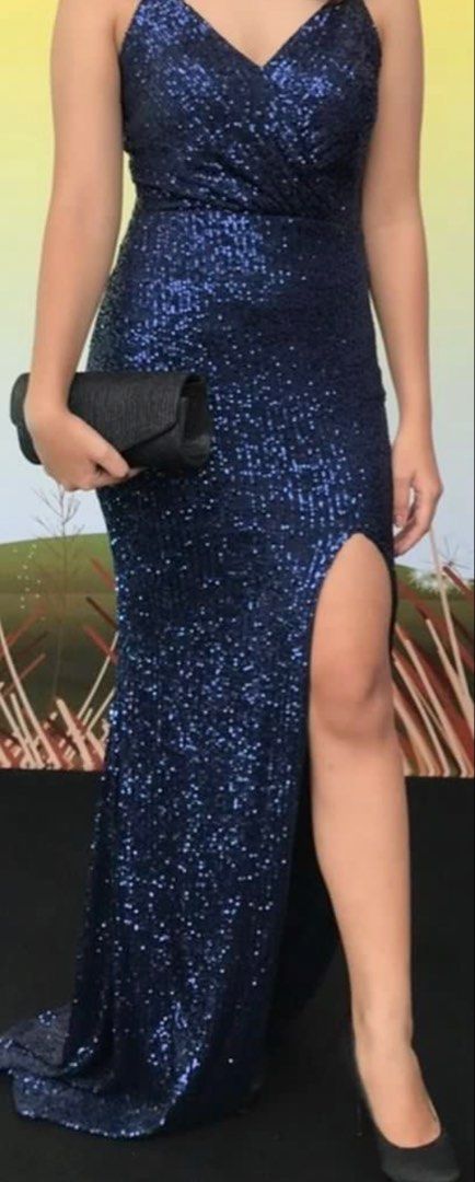Navy Blue Sequin Formal Evening Gown With High Slit (Category: Evening dresses & gowns) located in Quezon City. Submitted by cencen610 (Listing ID 1469792372, Image 2). Description: - Color: Stunning dark blue with all-over light-catching sequins - Style: V-neck wrap top with adjustable thin straps and a straight back - Size: XS to S built - Fit & Features: Floor-length with a slight train and a chic high side slit on the left leg - Perfect for: 
