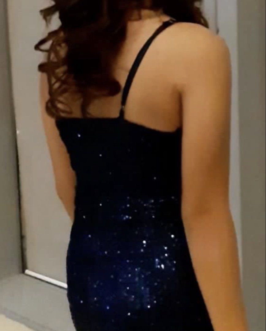 Navy Blue Sequin Formal Evening Gown With High Slit (Category: Evening dresses & gowns) located in Quezon City. Submitted by cencen610 (Listing ID 1469792372, Image 3). Description: - Color: Stunning dark blue with all-over light-catching sequins - Style: V-neck wrap top with adjustable thin straps and a straight back - Size: XS to S built - Fit & Features: Floor-length with a slight train and a chic high side slit on the left leg - Perfect for: 