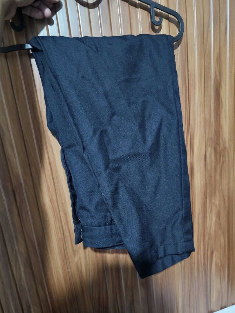 Navy Blue Slacks (Category: Trousers) located in Cainta. Submitted by ej_emuslan (Listing ID 1469784599, Image 2). Description: - Color: Solid black - Cut: Classic, ideal for work and smart-casual looks - Fabric: Textured material - Closure: Standard waistband with zipper and button - Versatility: Basic dark bottom that matches everything.