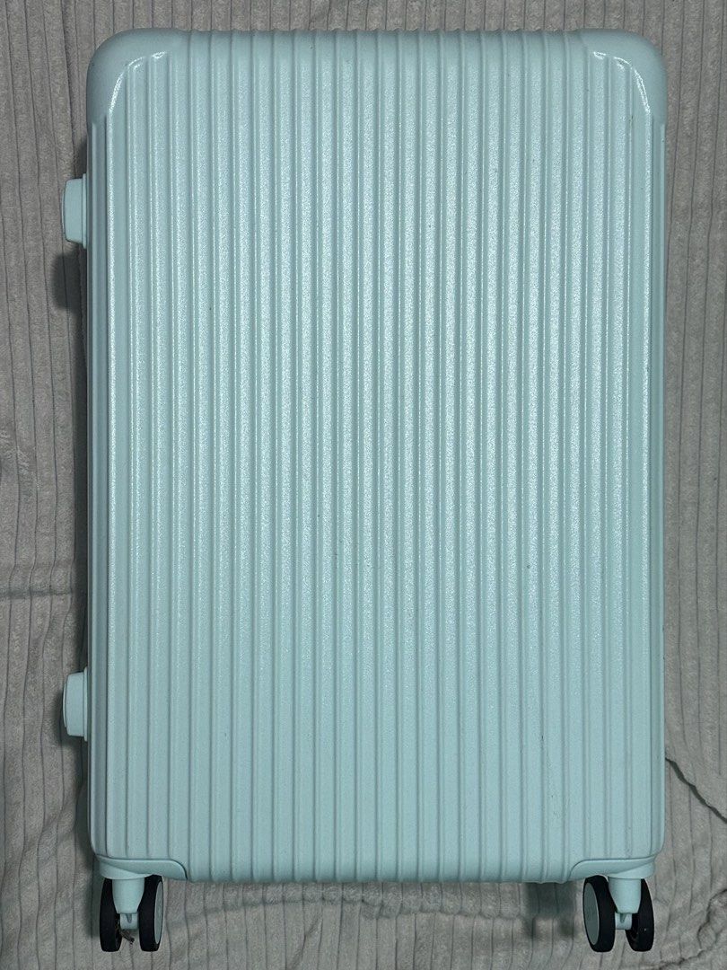 NEP Mint Green Luggage Striped (Category: Luggage) located in Quezon City. Submitted by shanebunag (Listing ID 1469824717, Image 1). Description: Light blue hardside suitcase with ribbed texture. Built-in combination lock on the side. Four smooth-rolling swivel wheels. Retractable handle and side handle wrapped in protective plastic. Fully lined interior in dark grey fabric, featuring zipper mesh compartments on one side and adjustable elastic pa