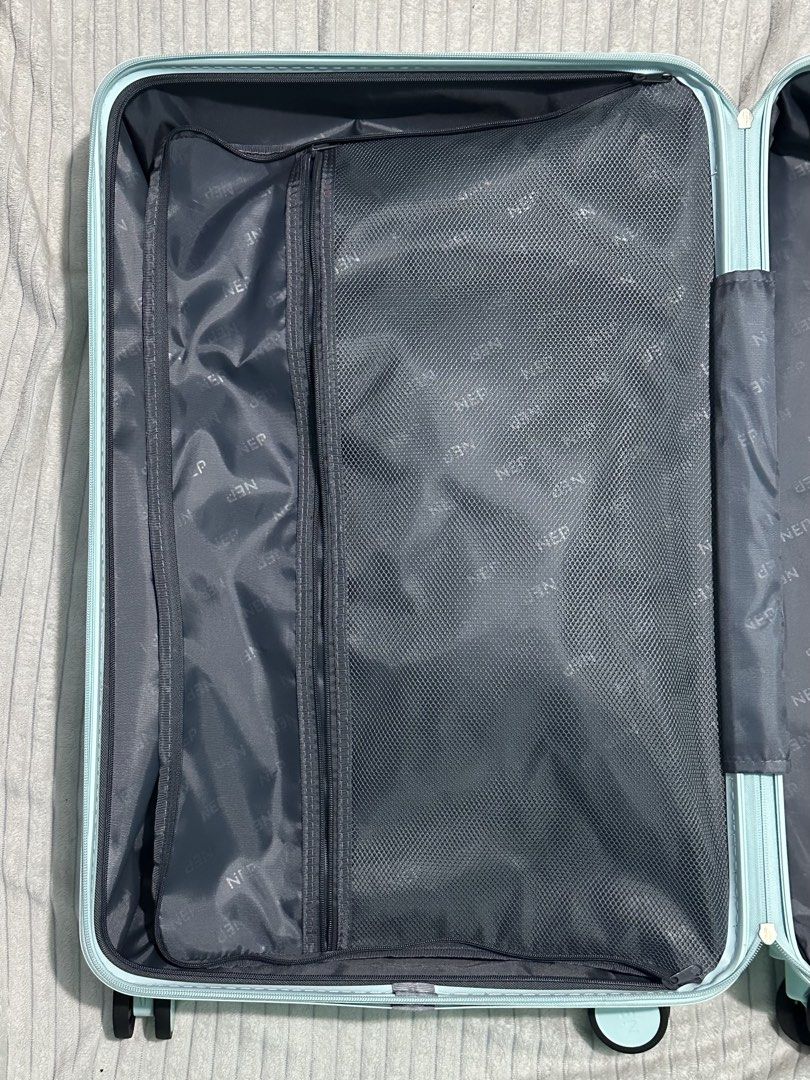 NEP Mint Green Luggage Striped (Category: Luggage) located in Quezon City. Submitted by shanebunag (Listing ID 1469824717, Image 3). Description: Light blue hardside suitcase with ribbed texture. Built-in combination lock on the side. Four smooth-rolling swivel wheels. Retractable handle and side handle wrapped in protective plastic. Fully lined interior in dark grey fabric, featuring zipper mesh compartments on one side and adjustable elastic pa