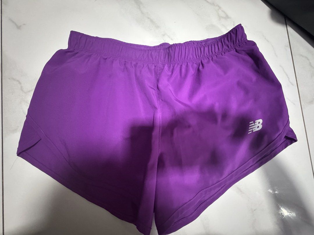 New Balance Purple Running Shorts (Category: Activewear) located in Manila. Submitted by decluterthings888 (Listing ID 1469834830, Image 1). Description: - Brand: New Balance - Color: Vibrant Purple - Fit: Comfortable elastic waistband - Design: Curved hem with small white logo on lower right leg - Material: Lightweight and breathable - Ideal for: Workouts, gym sessions, and daily runs.