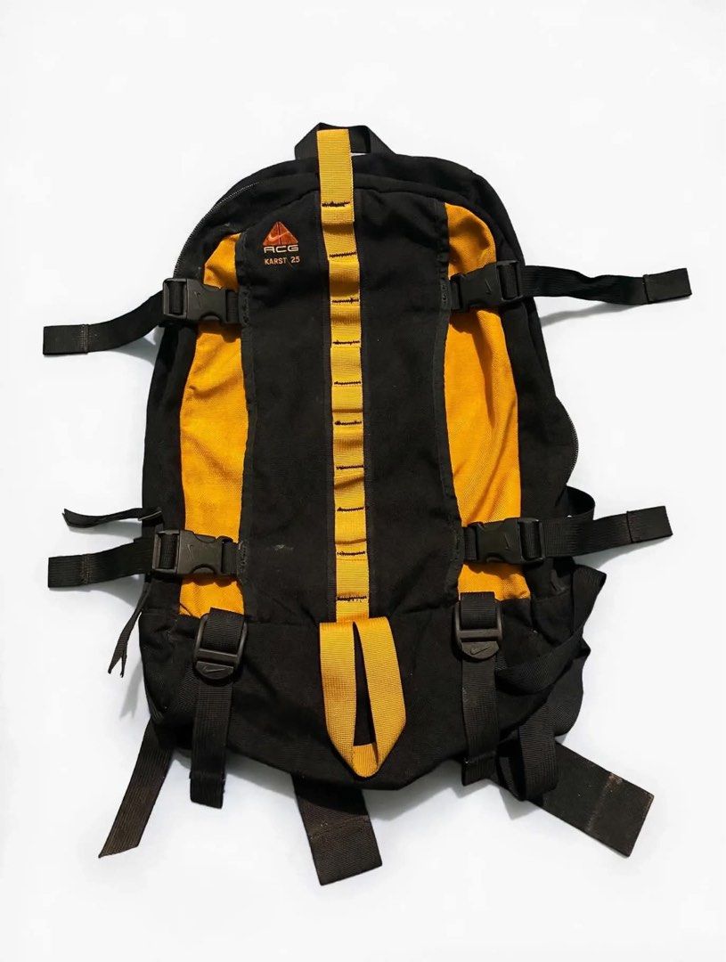Nike ACG Karst 25 Backpack Black Yellow (Category: Backpacks) located in Quezon City. Submitted by un0oo (Listing ID 1469923862, Image 1). Description: Nike ACG Karst 25 backpack in black and yellow colourway. Multiple buckle straps on the front and sides, central daisy chain webbing, and top haul loop. Padded shoulder straps with D-rings and a sternum strap equipped with a Nike buckle. Durable outdoor design with ample adjustment options..