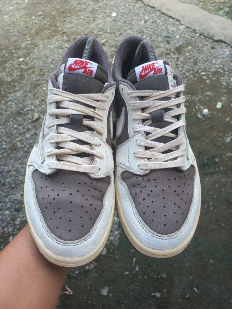 Nike Air Jordan 1 Low Travis Scott Reverse Mocha Size 12US (Category: Sneakers) located in Kalibo. Submitted by jofit2ndhandshoes (Listing ID 1469814521, Image 2). Description: - Model: Travis Scott Reverse Mocha Lows - Size: Men's US 12 - Design: Brown & white leather with signature reverse swoosh, Nike Air tongue tags, and heel Wings logo - Midsole: Classic cream-colored - Condition: Very clean pair - Inclusions: Shoe trees included to keep sha
