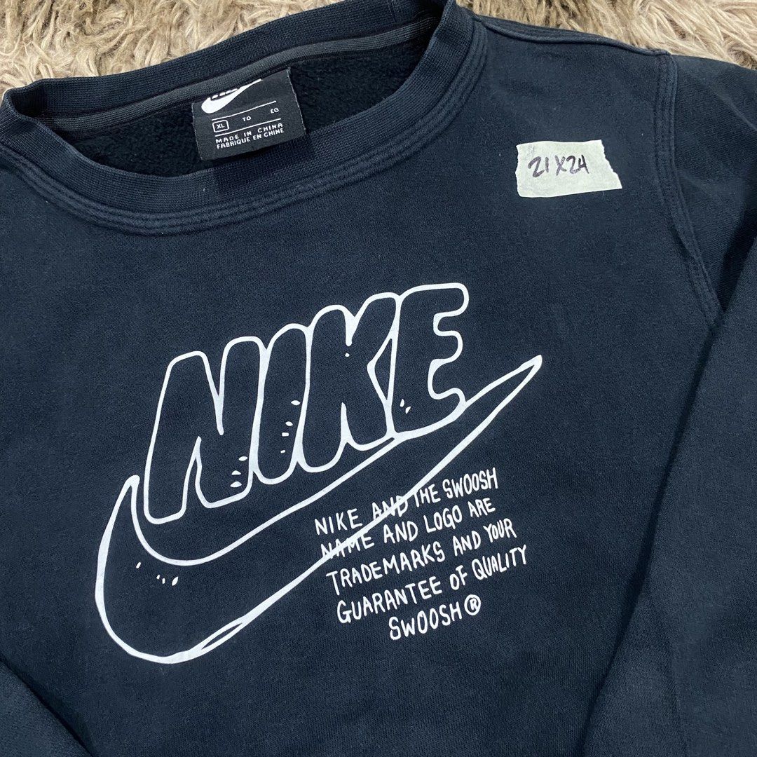 Nike Black Graphic Print Sweatshirt Size XL (Category: Coats, Jackets and Outerwear) located in Cagayan de Oro. Submitted by sepamorash53558 (Listing ID 1469796837, Image 2). Description: - Brand: Nike - Color: Black with large white chest graphic - Size: XL (Measures 21" x 24" inches) - Material: Comfortable cotton and polyester fleece blend - Details: Features trademark text and 'Property of' inside collar branding - Condition: Excellent pre-ow