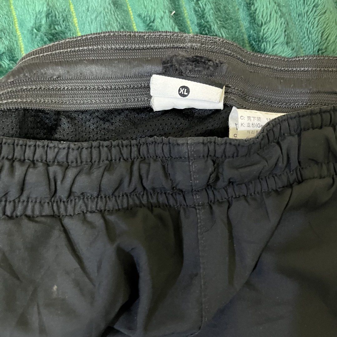 Nike Black Track Pants (Category: Joggers) located in Manila. Submitted by thriftkolngeh (Listing ID 1469935003, Image 3). Description: - Brand: Nike - Item: Windbreaker track pants - Color: Black - Size: XL - Condition: Excellent / Pre-loved (as described) - Waistband: Elastic with adjustable drawcord - Branding: Embroidered white Nike swoosh on left thigh with small logo graphic - Pockets: Secure zip pockets on both sides - Interior: Breathable