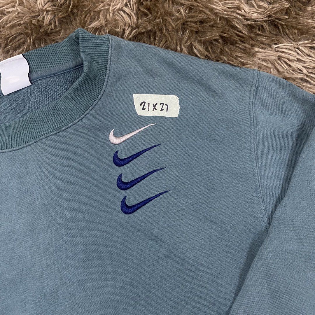 Nike Blue Multi Swoosh Sweatshirt Size S (Category: Coats, Jackets and Outerwear) located in Cagayan de Oro. Submitted by sepamorash53558 (Listing ID 1469797722, Image 2). Description: - Brand: Nike - Item: Blue crewneck sweatshirt with embroidered multi swoosh logo - Size: S (Pit-to-pit: 21 inches, Length: 27 inches) - Material: 88% cotton, 12% polyester - Details: Ribbed collar, cuffs, and hem - Origin: Made in China - Condition: Clean piece, c