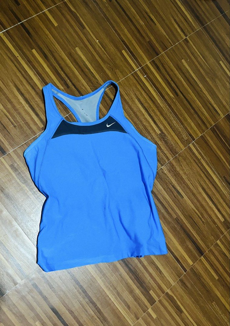 Nike Blue Vintage Top (Category: Activewear) located in Manila. Submitted by zendog_a92acc (Listing ID 1469825836, Image 1). Description: - Brand: Nike - Color: Bright blue with dark grey chest panel - Design: Racerback style with signature Nike swoosh logo - Comfort: Breathable mesh inner layer at the back - Ideal for: Gym workouts, running, and casual activewear.