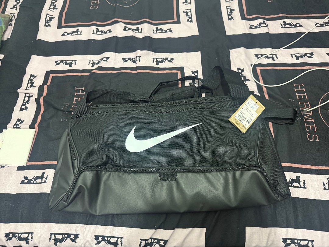 Nike Brasilia Training Duffel Bag Black Medium (Category: Sling Bags) located in Manila. Submitted by arelef (Listing ID 1469901971, Image 2). Description: - Brand new, never used with original tags still attached - Authentic black Nike duffel bag featuring a bold white swoosh logo - Spacious interior perfect for gym gear, sports equipment, or travel clothes - Built with durable handles and secure, heavy-duty zippers - Includes original paper sho