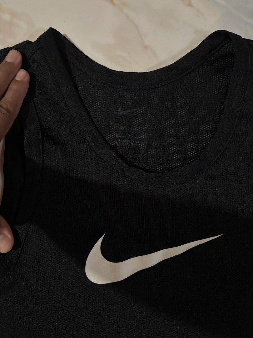 Nike Dri-FIT Black Training Tank Top Size L (Category: Activewear) located in Dumaguete. Submitted by revillahar03975 (Listing ID 1469778902, Image 2). Description: - Brand: Nike - Item: Black training tank top - Size: L - Material: Breathable Dri-FIT mesh fabric for cooling - Design: Large white Swoosh graphic on the chest - Style Code: BV9388-010 - Condition: Clean, no stains, no holes.