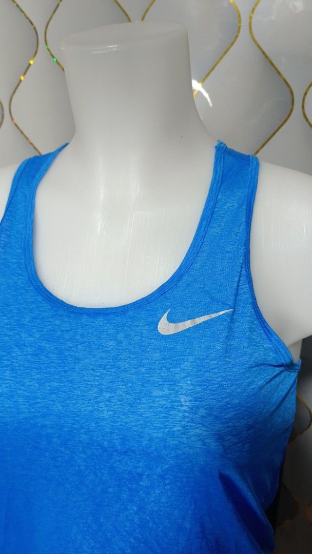 Nike Dri-FIT Blue Athletic Tank Top (Category: Activewear) located in Manila. Submitted by zariyah.1986 (Listing ID 1469863330, Image 2). Description: - Brand: Nike - Item: Athletic Tank Top - Color: Bright Blue - Size: Small - Material: Dri-FIT moisture-wicking fabric - Features: Racerback design, reflective front swoosh logo - Measurements: 15.5" across chest, 23" length - Origin: Made in Sri Lanka - Condition: Excellent for workouts.