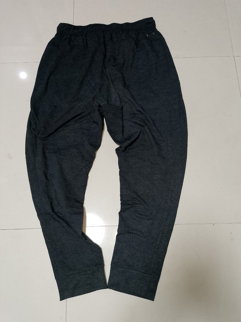 Nike Dri-FIT Grey Sweatpants XL (Category: Joggers) located in Manila. Submitted by mjthrifted_second (Listing ID 1469830613, Image 2). Description: Code 5 - Brand: Nike - Style: Dri-FIT sweatpants - Color: Dark grey melange - Size: XL - Origin: Made in Indonesia - Fit: Tapered cut with ribbed ankle cuffs - Features: Elastic waist with adjustable black drawstring, reflective silver Nike swoosh logo, soft fleece-like interior - Condition: Excellen