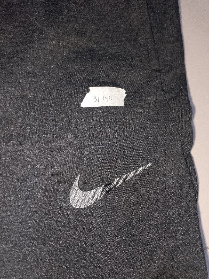 Nike Dri-FIT Grey Sweatpants XL (Category: Joggers) located in Manila. Submitted by mjthrifted_second (Listing ID 1469830613, Image 3). Description: Code 5 - Brand: Nike - Style: Dri-FIT sweatpants - Color: Dark grey melange - Size: XL - Origin: Made in Indonesia - Fit: Tapered cut with ribbed ankle cuffs - Features: Elastic waist with adjustable black drawstring, reflective silver Nike swoosh logo, soft fleece-like interior - Condition: Excellen